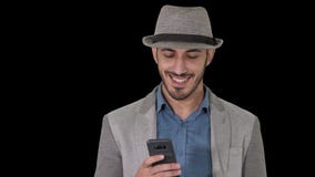 Smart casual arabian man using smartphone while walking, Alpha Channel stock video footage Smart casual arabian man using smartphone while walking, Alpha Channel stock video footage