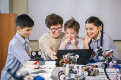 Curious children learn programming using laptops on extracurricular classes stock images Curious children learn programming using laptops on extracurricular classes stock images