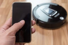 Smart robot vacuum cleaning control with smart phone royalty free stock images Smart robot vacuum cleaning control with smart phone royalty free stock images