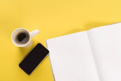 Smartphone and cup of coffee with mock-up magazine stock images Smartphone and cup of coffee with mock-up magazine stock images