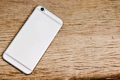 Smartphone on the wooden table stock photo Smartphone on the wooden table stock photo