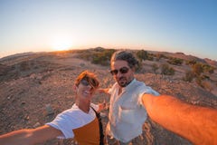 Smiling adult couple taking selfie in the Namib desert, Namib Naukluft National Park, main travel destination in Namibia, Africa. Stock Photo Smiling adult couple taking selfie in the Namib desert, Namib Naukluft National Park, main travel destination in Namibia, Africa. Stock Photo