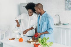 https://thumbs.dreamstime.com/t/smiling-african-american-woman-pouring-milk-glass-husband-cooking-breakfast-kitchen-home-smiling-african-american-127699831.jpg