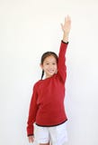 Smiling Asian Little Girl In Red Long Sleeve Shirt Holding Hand Up Isolated On White Background Royalty Free Stock Photography Smiling Asian Little Girl In Red Long Sleeve Shirt Holding Hand Up Isolated On White Background Royalty Free Stock Photography