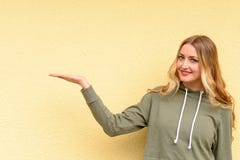Smiling attractive blond woman holding out a hand stock images Smiling attractive blond woman holding out a hand stock images
