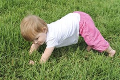Smiling Baby Learning To Stand Up In Green Grass Stock Images