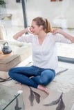 Smiling beautiful young woman with crossed legs stretching her arms royalty free stock image Smiling beautiful young woman with crossed legs stretching her arms royalty free stock image