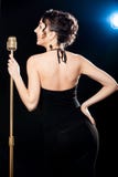 Smiling beautiful young woman singer holding golden vintage micr royalty free stock photos Smiling beautiful young woman singer holding golden vintage micr royalty free stock photos