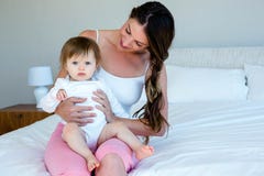 smiling brunette woman holding a cute baby royalty free stock photos smiling brunette woman holding a cute baby royalty free stock photos