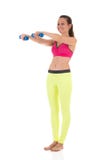 Smiling brunette woman in sports neon yellow leggings and pink bra doing complex exercises for muscles of hands using dumbbell. Sportive smiling brunette woman Royalty Free Stock Image Smiling brunette woman in sports neon yellow leggings and pink bra doing complex exercises for muscles of hands using dumbbell. Sportive smiling brunette woman Royalty Free Stock Image