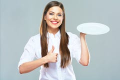 Smiling Business woman holding emty white plate with thumd up.