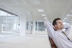 Smiling Businessman On Chair In New Office Stock Photo Smiling Businessman On Chair In New Office Stock Photo