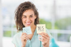 Smiling businesswoman holding yes and no sticks Stock Photography Smiling businesswoman holding yes and no sticks Stock Photography