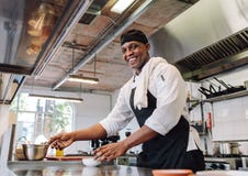 Smiling chef cooking food at restaurant kitchen royalty free stock image Smiling chef cooking food at restaurant kitchen royalty free stock image