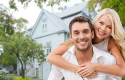 Smiling couple hugging over house background Royalty Free Stock Photos Smiling couple hugging over house background Royalty Free Stock Photos