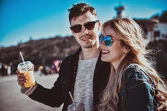 Cute couple having fun, walking at the street and drink a cocktails royalty free stock photos Cute couple having fun, walking at the street and drink a cocktails royalty free stock photos