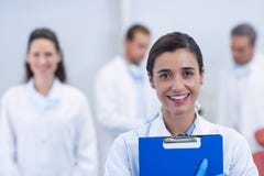 Smiling dentist standing at dental clinic stock image Smiling dentist standing at dental clinic stock image