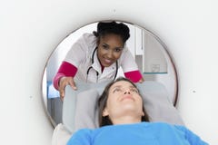 Smiling Doctor Preparing Patient For CT Scan royalty free stock photo Smiling Doctor Preparing Patient For CT Scan royalty free stock photo