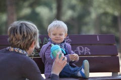 Smiling,eating baby girl with her mother stock photography Smiling,eating baby girl with her mother stock photography
