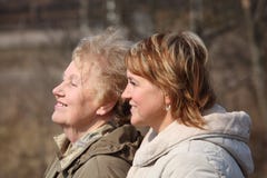 Smiling elderly woman and her daughter in profile royalty free stock images Smiling elderly woman and her daughter in profile royalty free stock images
