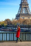 Smiling elegant woman on embankment in Paris, France walking Royalty Free Stock Photos Smiling elegant woman on embankment in Paris, France walking Royalty Free Stock Photos
