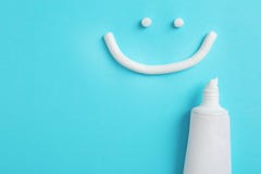 Smiling face made of toothpaste, tube on color background, top view royalty free stock photo Smiling face made of toothpaste, tube on color background, top view royalty free stock photo
