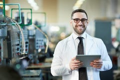 Smiling Factory Worker Holding Tablet royalty free stock image Smiling Factory Worker Holding Tablet royalty free stock image