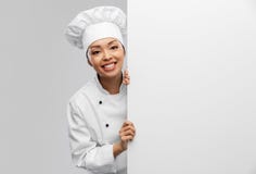 smiling female chef with white board