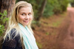 Smiling female hiker waiting by the side of the road Stock Photo Smiling female hiker waiting by the side of the road Stock Photo