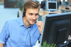 Smiling friendly handsome young male call centre operator. Stock Photos Smiling friendly handsome young male call centre operator. Stock Photos