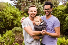 Smiling gay couple with child Stock Photography Smiling gay couple with child Stock Photography