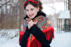 Winter portreit smiling girl with beautiful hair on her head in Russian folk style in red shawls royalty free stock photos Winter portreit smiling girl with beautiful hair on her head in Russian folk style in red shawls royalty free stock photos