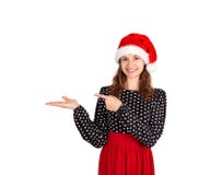 Smiling girl in dress shows the finger. emotional girl in santa claus christmas hat isolated on white background. holiday concept royalty free stock image Smiling girl in dress shows the finger. emotional girl in santa claus christmas hat isolated on white background. holiday concept royalty free stock image