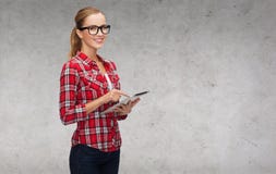 Smiling girl in eyeglasses with tablet pc computer Stock Photography Smiling girl in eyeglasses with tablet pc computer Stock Photography