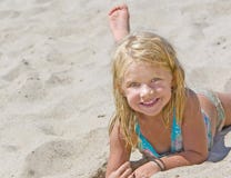Smiling Girl On Sand Stock Photography