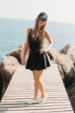 smiling girl posing on wooden pier at rocks royalty free stock image smiling girl posing on wooden pier at rocks royalty free stock image