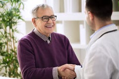 Smiling happy healthy old male shaking with doctor royalty free stock image Smiling happy healthy old male shaking with doctor royalty free stock image