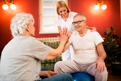 Smiling happy old senior people exercises together with nurse stock image Smiling happy old senior people exercises together with nurse stock image