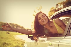 Smiling happy traveling young woman looking from the new car win stock photo Smiling happy traveling young woman looking from the new car win stock photo