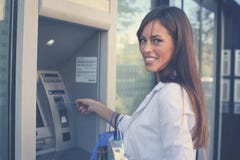 Smiling happy woman with shopping bags at ATM. Looking at camer royalty free stock photos Smiling happy woman with shopping bags at ATM. Looking at camer royalty free stock photos
