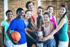 Smiling high school kids holding trophy in basketball court stock images Smiling high school kids holding trophy in basketball court stock images