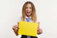 A smiling high school student, blonde with curly hair, holds a blank paper of yellow color, on which can be your promotional infor stock image A smiling high school student, blonde with curly hair, holds a blank paper of yellow color, on which can be your promotional infor stock image