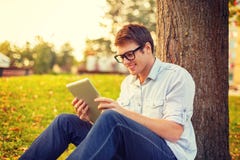 Smiling male student in eyeglasses with tablet pc royalty free stock images Smiling male student in eyeglasses with tablet pc royalty free stock images