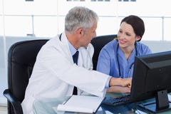 Smiling medical team working with a computer Royalty Free Stock Photo Smiling medical team working with a computer Royalty Free Stock Photo