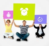 Smiling people holding board in clock symbol stock photos Smiling people holding board in clock symbol stock photos