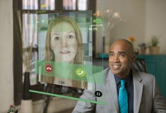Smiling Professional Man Having Phone Conversation using a Futur Royalty Free Stock Image Smiling Professional Man Having Phone Conversation using a Futur Royalty Free Stock Image