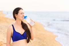 Woman drinks water on the sea beach royalty free stock photo Woman drinks water on the sea beach royalty free stock photo