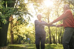 Senior couple in forest holding hands and rotate in circ royalty free stock image Senior couple in forest holding hands and rotate in circ royalty free stock image