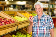 Smiling senior man holding apple royalty free stock photo Smiling senior man holding apple royalty free stock photo