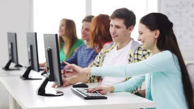Smiling students working with computers at school stock video footage Smiling students working with computers at school stock video footage